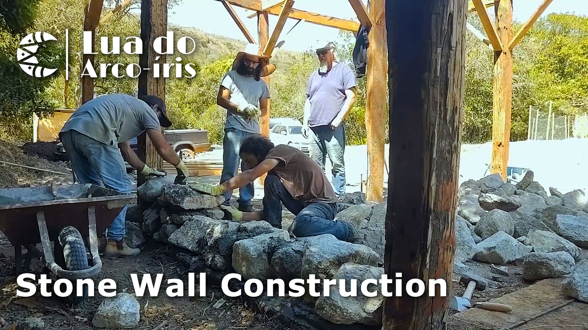 men building a stone wall cabin